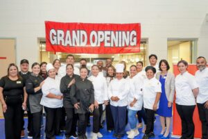 Beyond the Kitchen chefs posing in front of their new commercial kitchen space in Emmanuel Baptist church